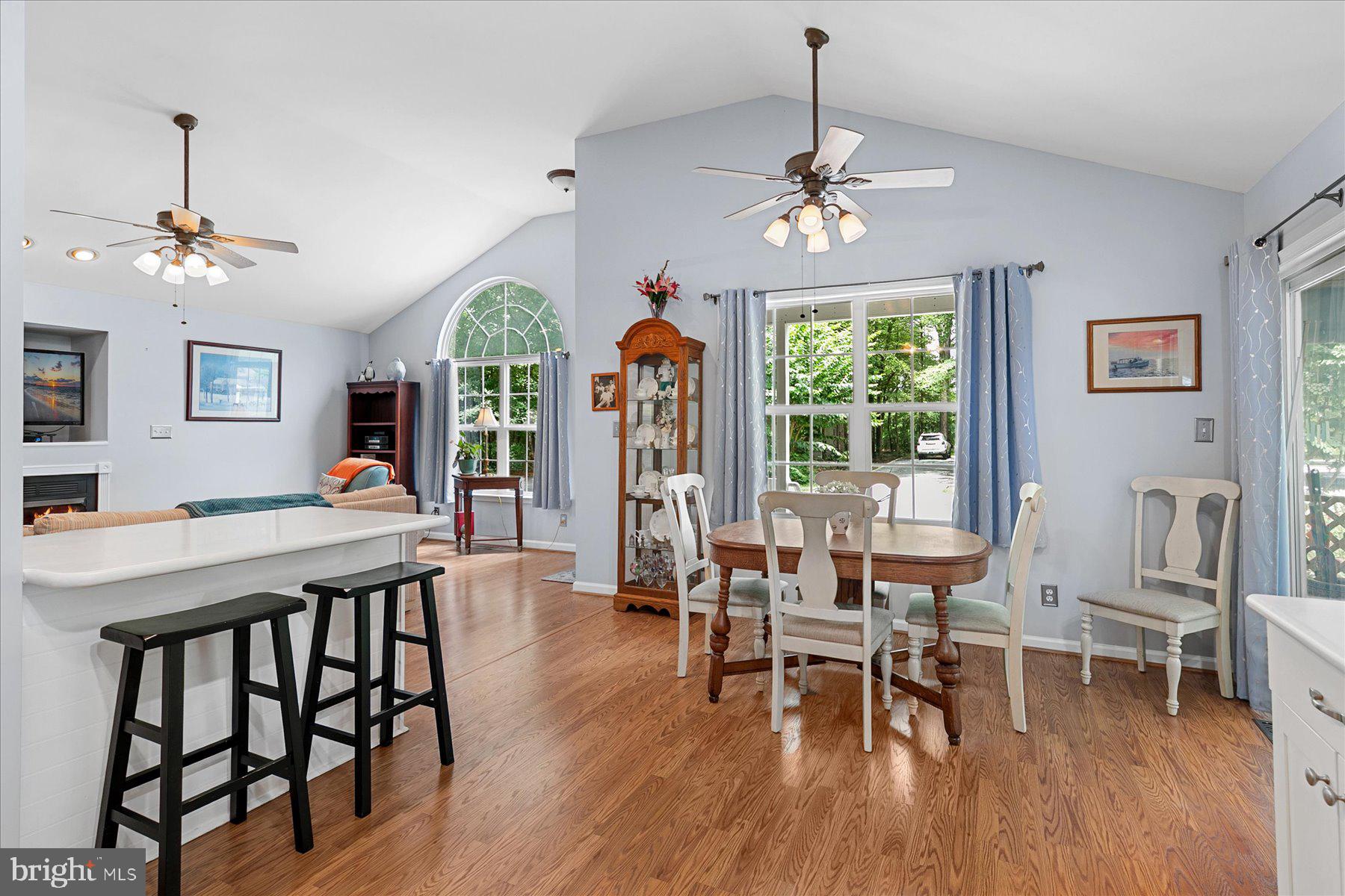 120 Pinehurst Road Berlin, MD 21811 - Photo 12 of 37 a dining room with wooden floor a chandelier a wooden table and chairs