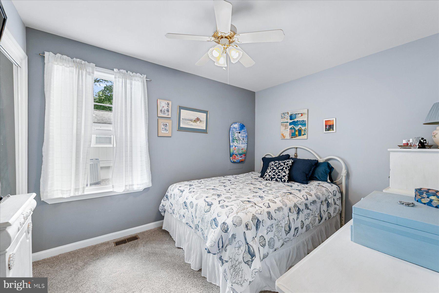120 Pinehurst Road Berlin, MD 21811 - Photo 23 of 37 a bedroom with a bed and a chandelier