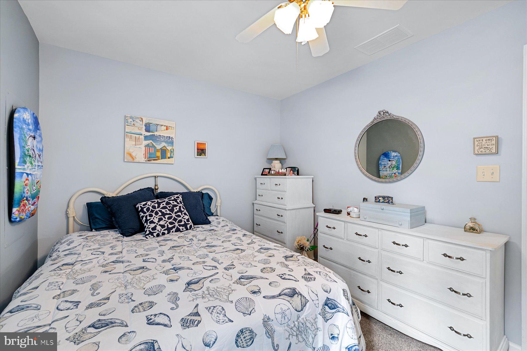 120 Pinehurst Road Berlin, MD 21811 - Photo 24 of 37 a bedroom with a bed and a chandelier