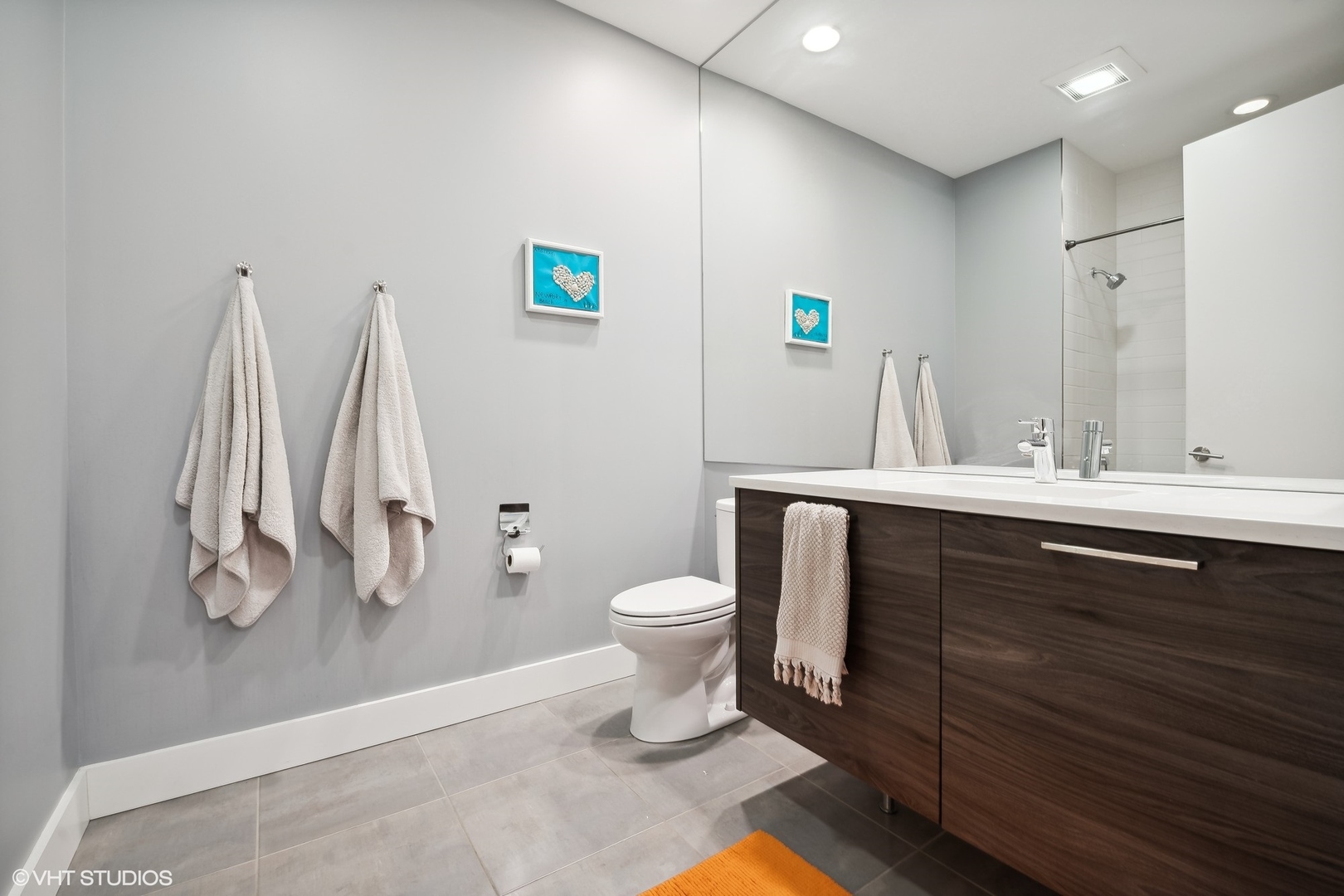 1120 West Adams Street, Unit 3E Chicago, IL 60607 - Photo 12 of 21 a bathroom with a sink a toilet and a mirror