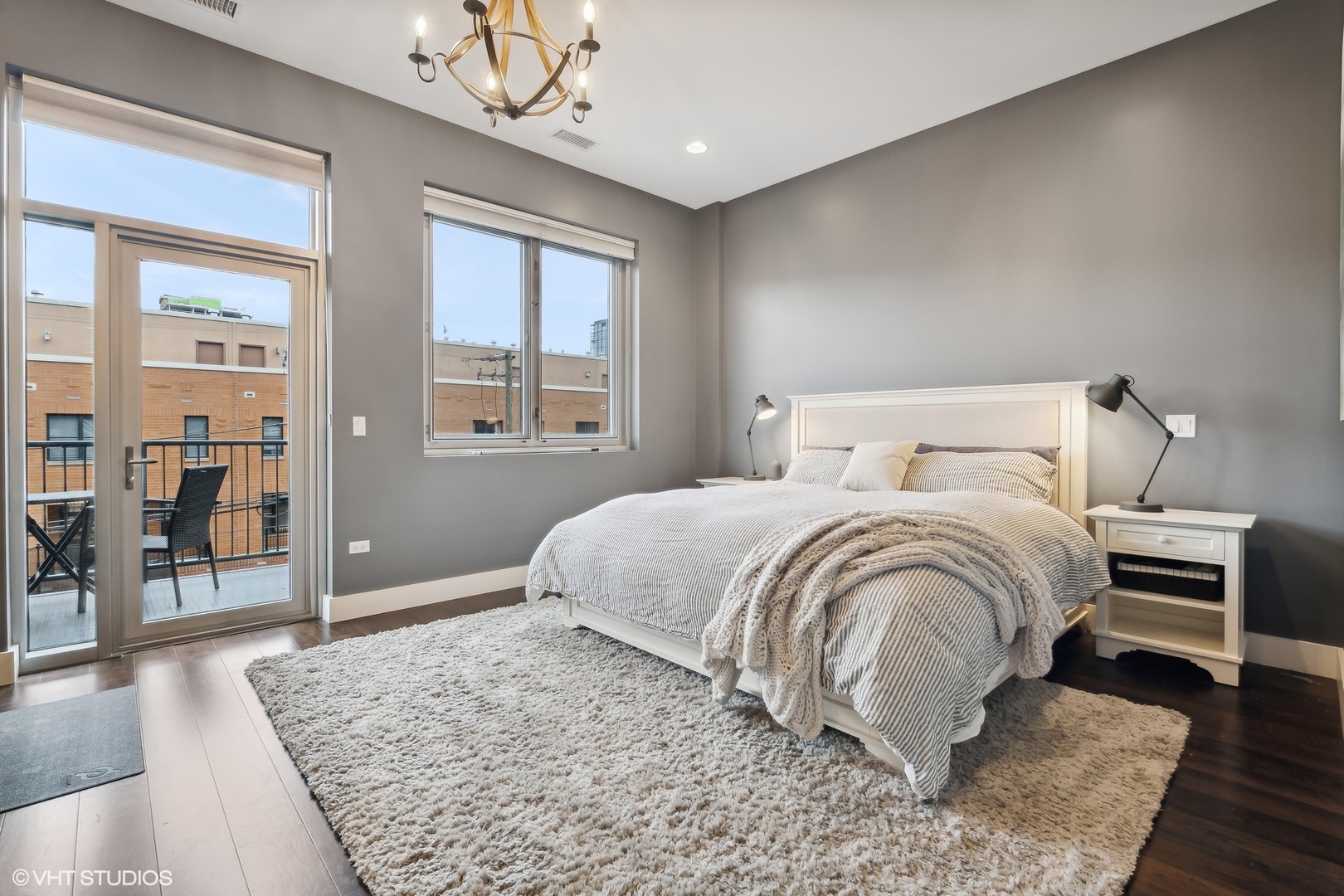 1120 West Adams Street, Unit 3E Chicago, IL 60607 - Photo 13 of 21 a bedroom with a large bed a chandelier and windows