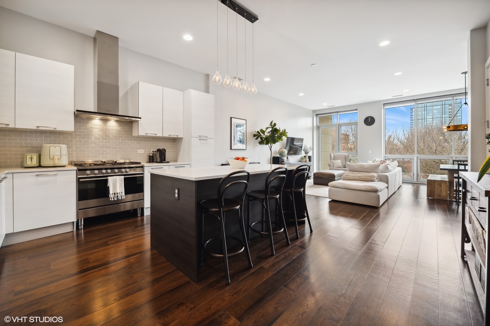 1120 West Adams Street, Unit 3E Chicago, IL 60607 - Photo 2 of 21 a kitchen with stainless steel appliances granite countertop wooden floors and view living room