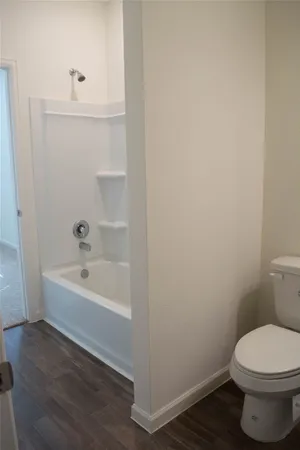 a bathroom with a toilet and a bathtub