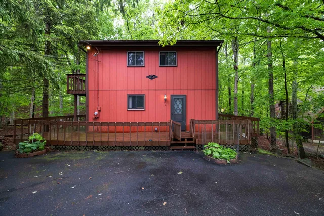 a red brick house with trees in the background