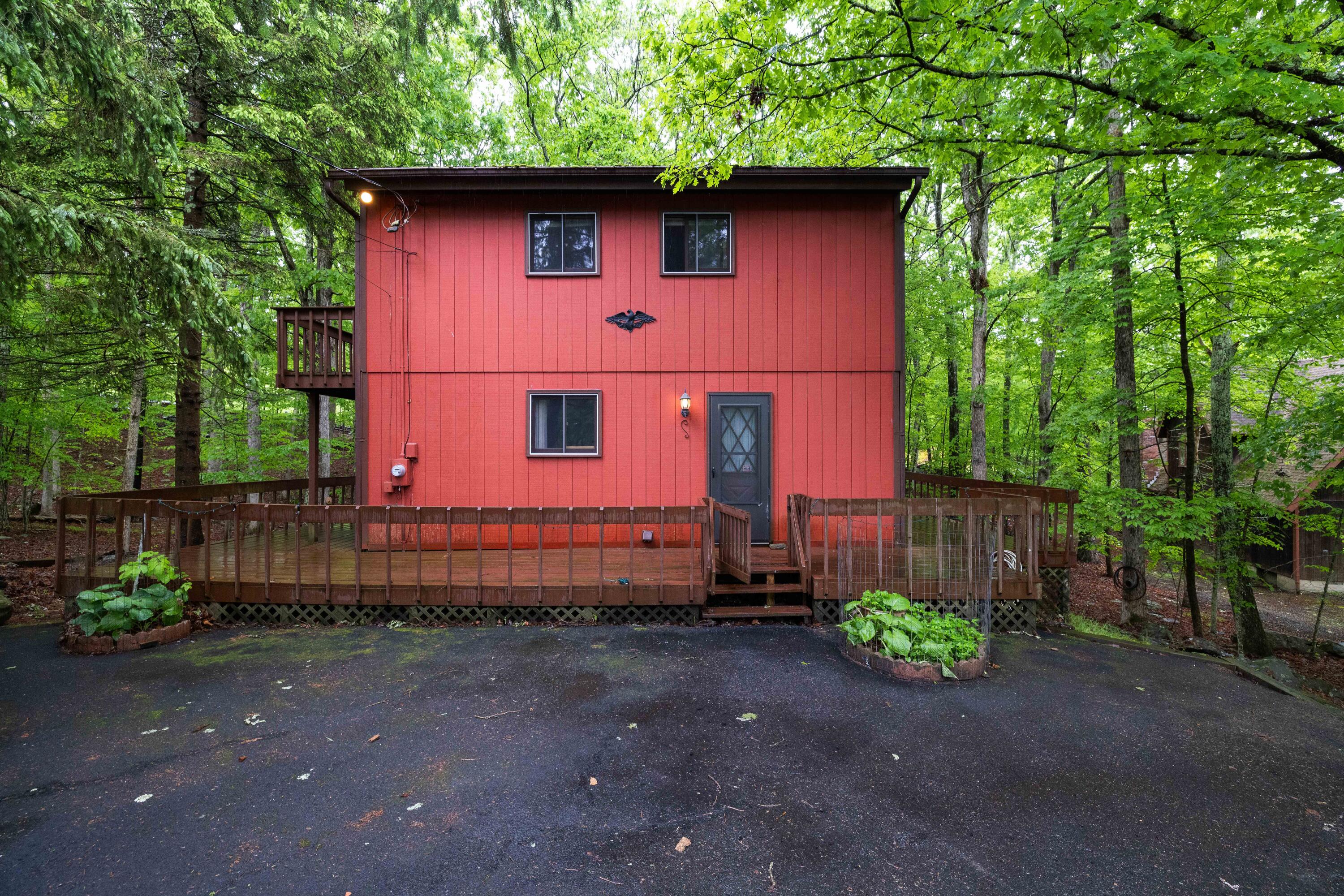 a red brick house with trees in the background