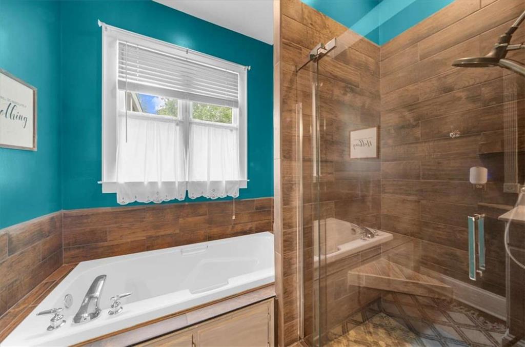 106 Westmore Road Southwest Rome, GA 30165 - Photo 44 of 56 a bathroom with a bathtub and a shower