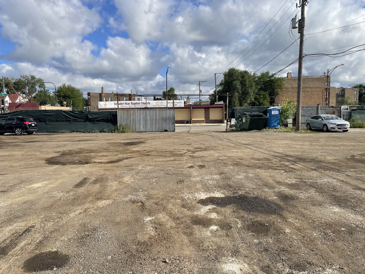 4337 West 16th Street Chicago, IL 60623 - Photo 4 of 5 a view of road with card parked on side and retail shops
