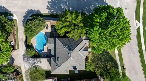 an aerial view of a house with a yard and potted plants