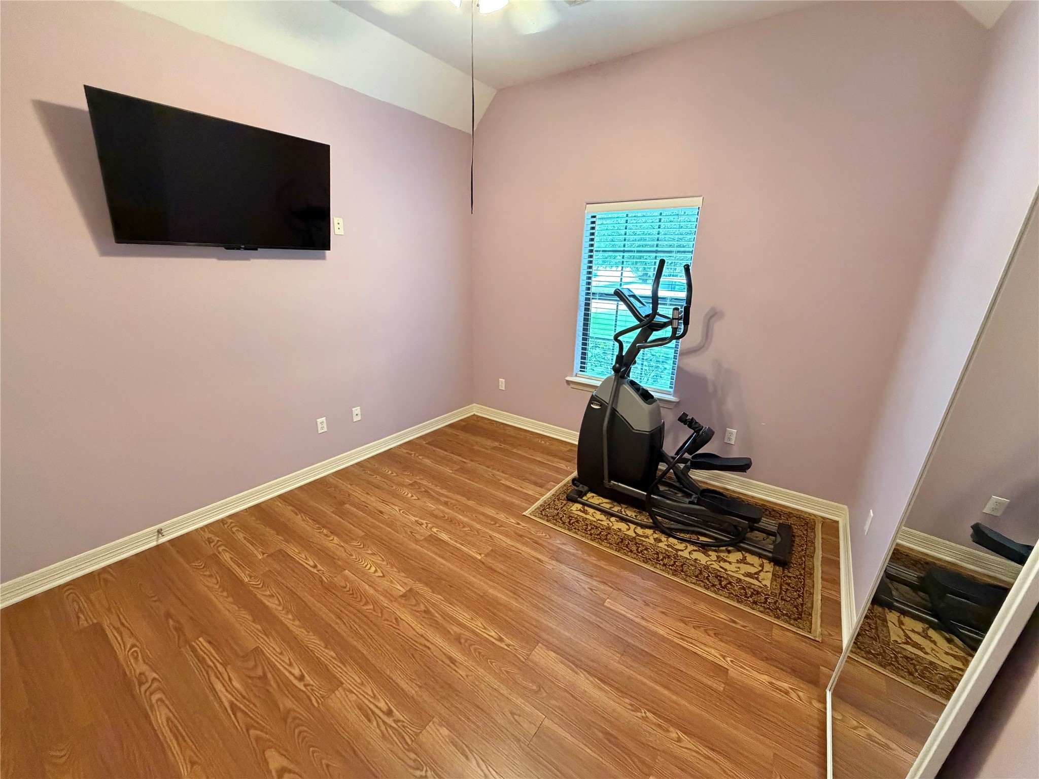 1448 South Blue Bonnet Lane Angleton, TX 77515 - Photo 22 of 43 a living room with a flat screen tv a rug and a window