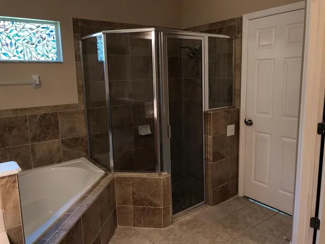 a bathroom with a tub and shower
