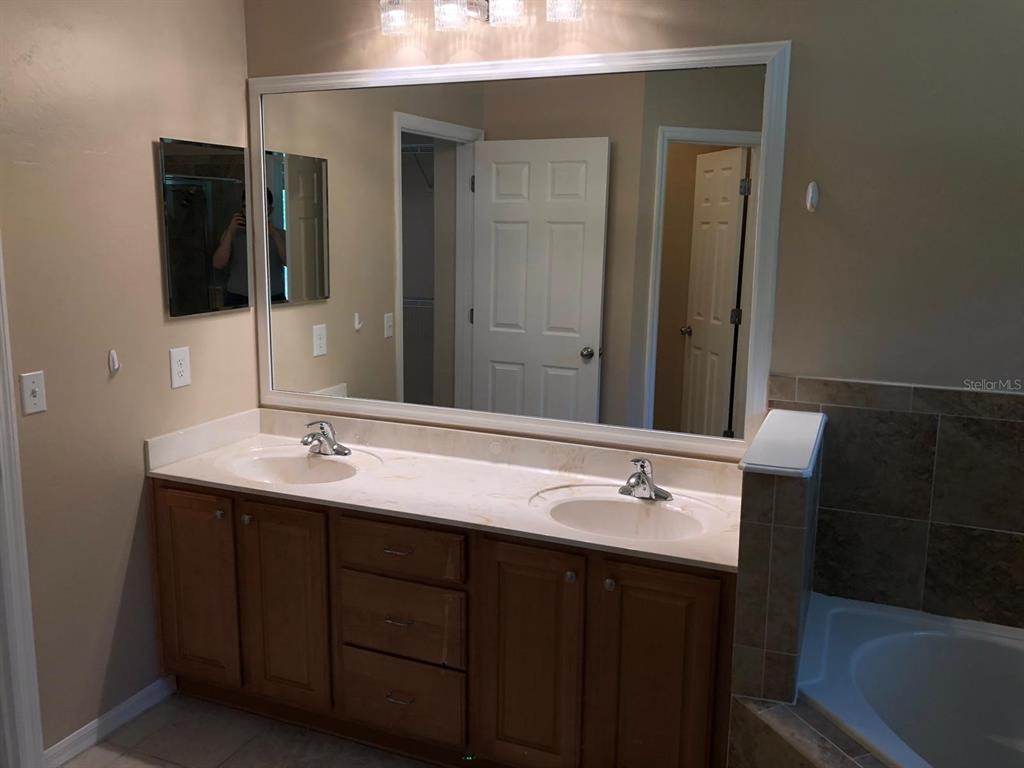 9964 Northwest 22nd Road Gainesville, FL 32606 - Photo 12 of 20 a bathroom with a sink and a mirror