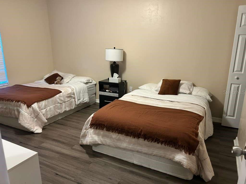 9964 Northwest 22nd Road Gainesville, FL 32606 - Photo 16 of 20 a bedroom with two beds and wooden floor