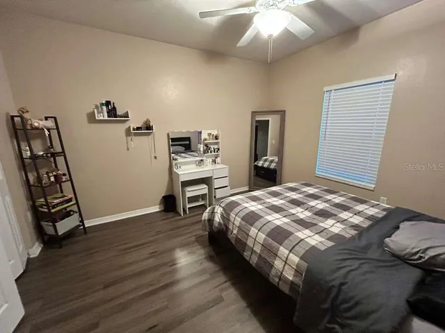a bedroom with a bed and a flat tv screen