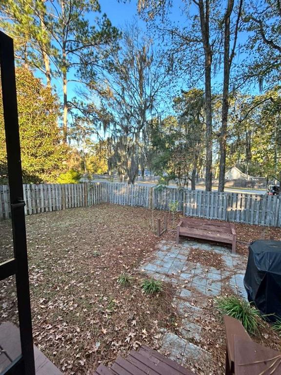 9964 Northwest 22nd Road Gainesville, FL 32606 - Photo 19 of 20 a view of a yard with wooden fence