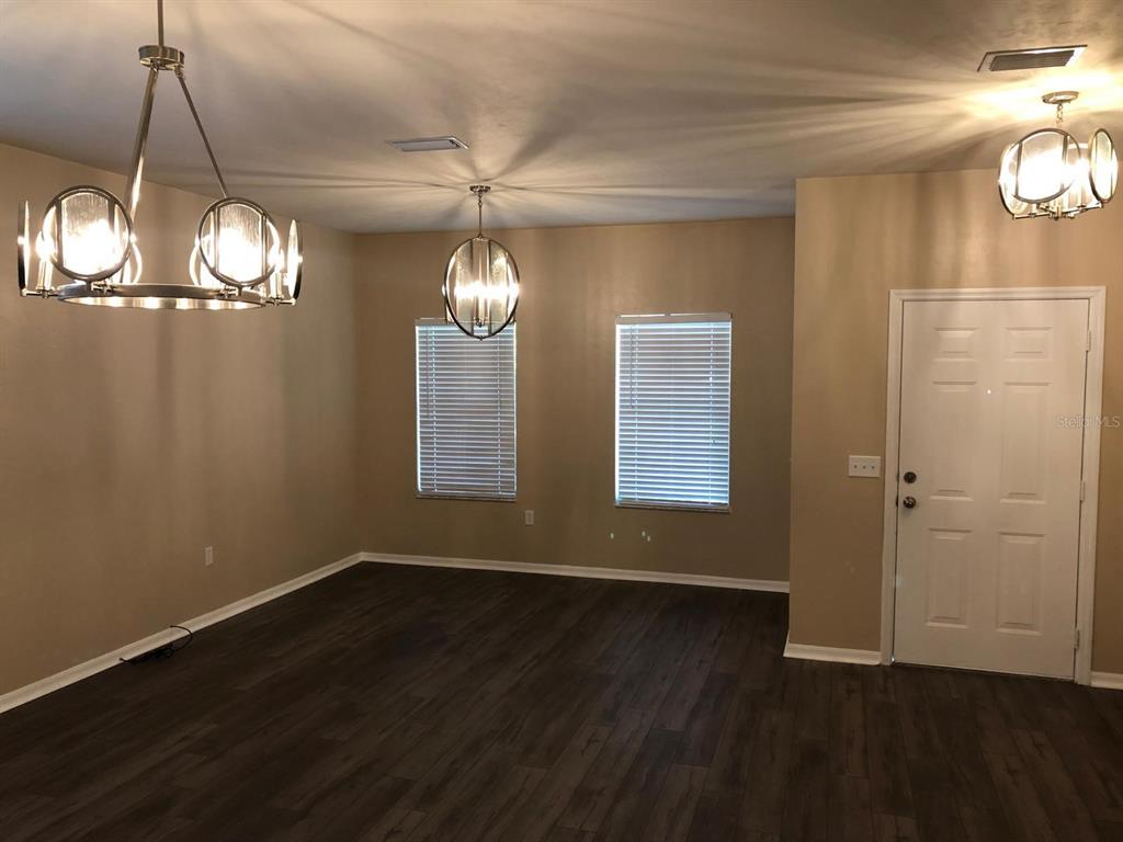 9964 Northwest 22nd Road Gainesville, FL 32606 - Photo 2 of 20 an empty room with wooden floor and windows