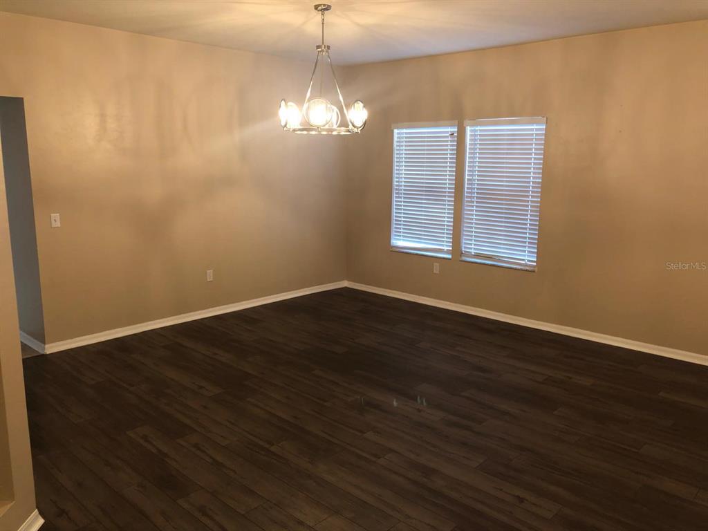 9964 Northwest 22nd Road Gainesville, FL 32606 - Photo 3 of 20 a view of wooden floor and windows in a room