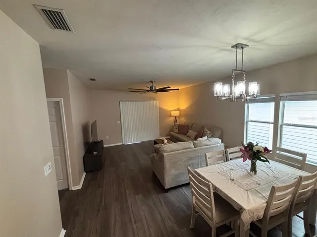 a very nice looking dining room with a table and chairs