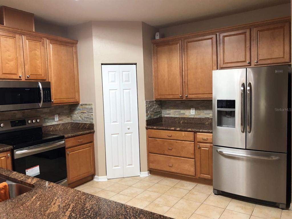 9964 Northwest 22nd Road Gainesville, FL 32606 - Photo 6 of 20 a kitchen with a refrigerator stove and microwave