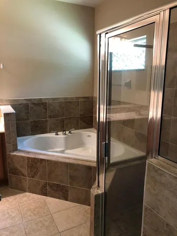 a bathroom with a bathtub and a shower