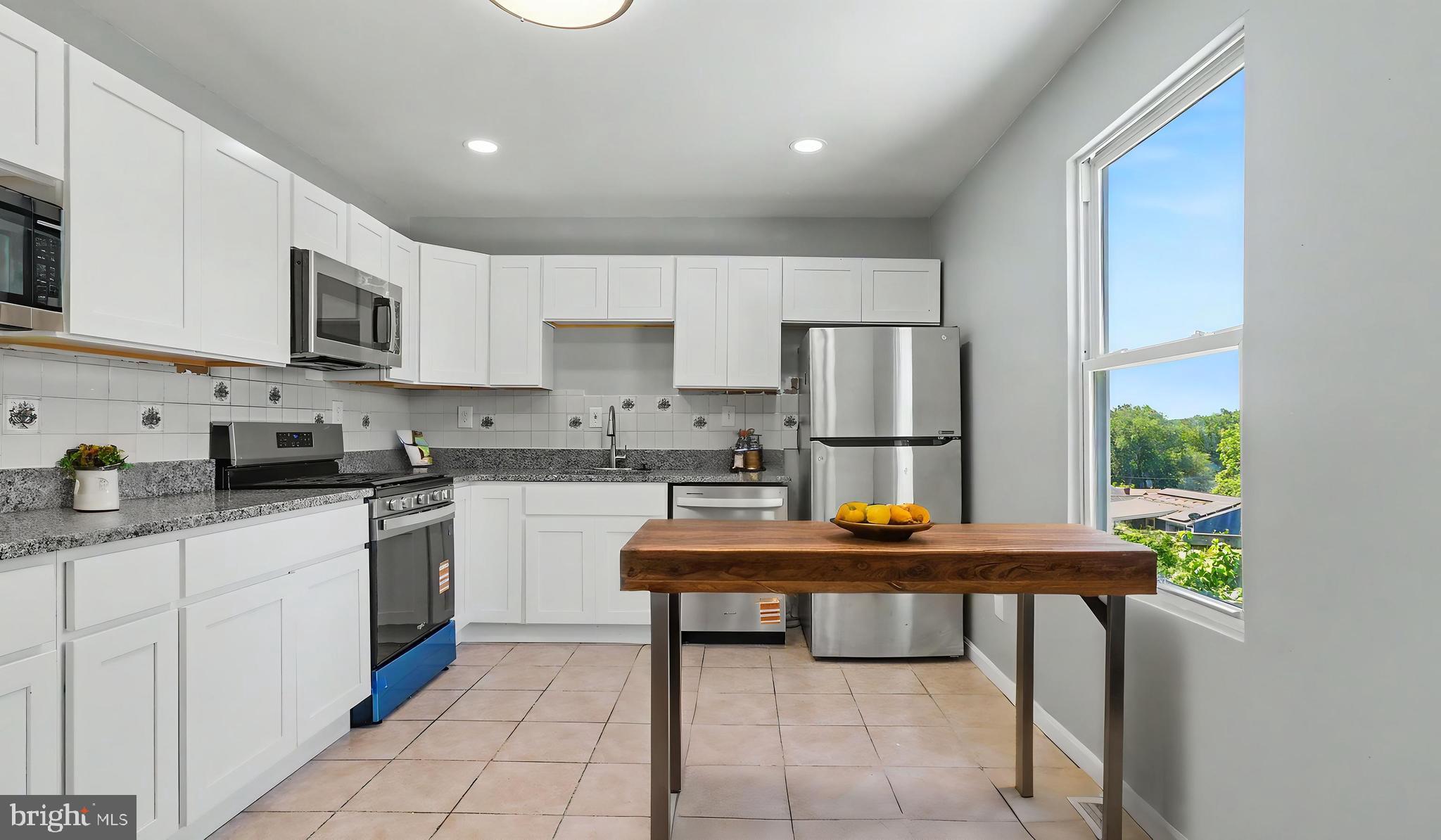 4203 Shell Street Capitol Heights, MD 20743 - Photo 41 of 47 a kitchen with stainless steel appliances granite countertop a refrigerator sink and cabinets