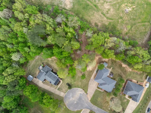 an aerial view of a house with a yard basket ball court and outdoor seating