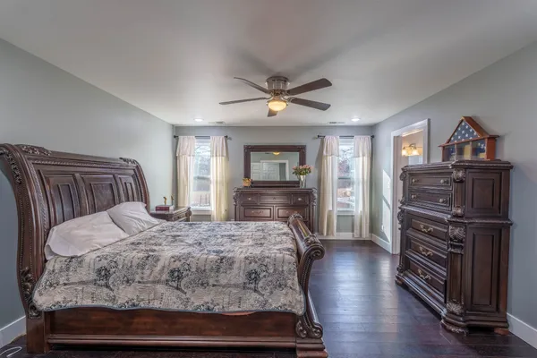 a bedroom with a bed and a chandelier
