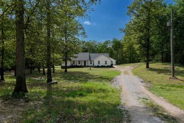 a view of a house with a yard and garage
