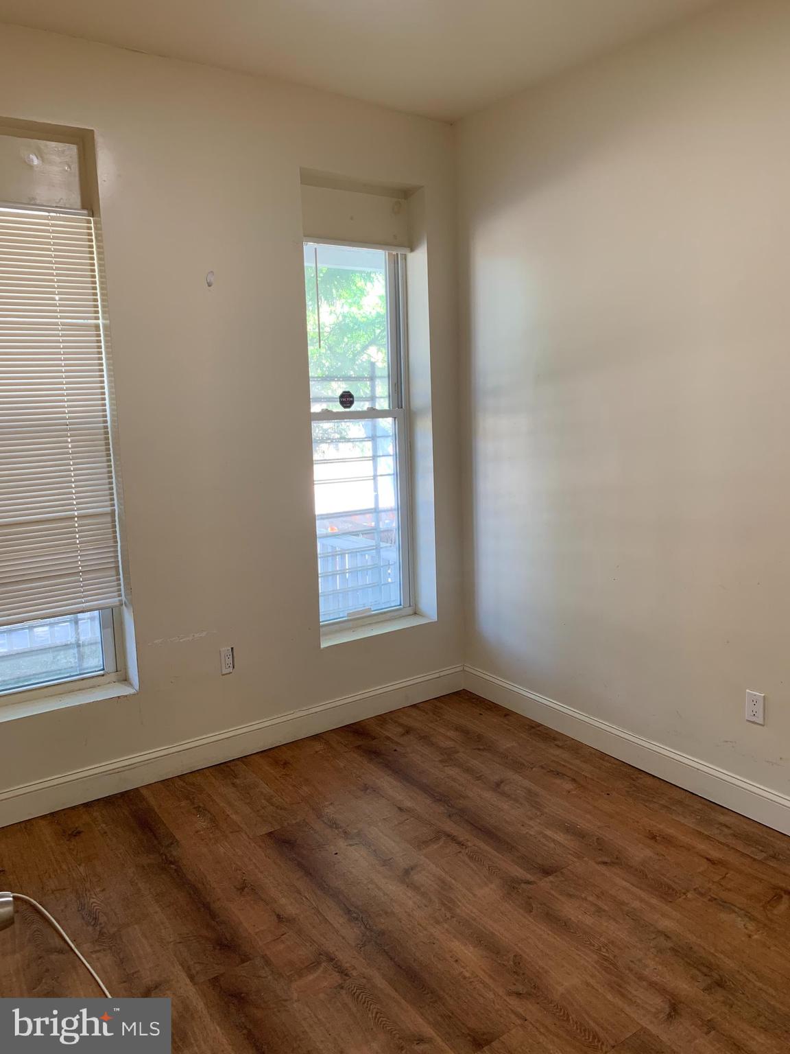 322 North Pulaski Street Baltimore, MD 21223 - Photo 12 of 26 an empty room with wooden floor and windows