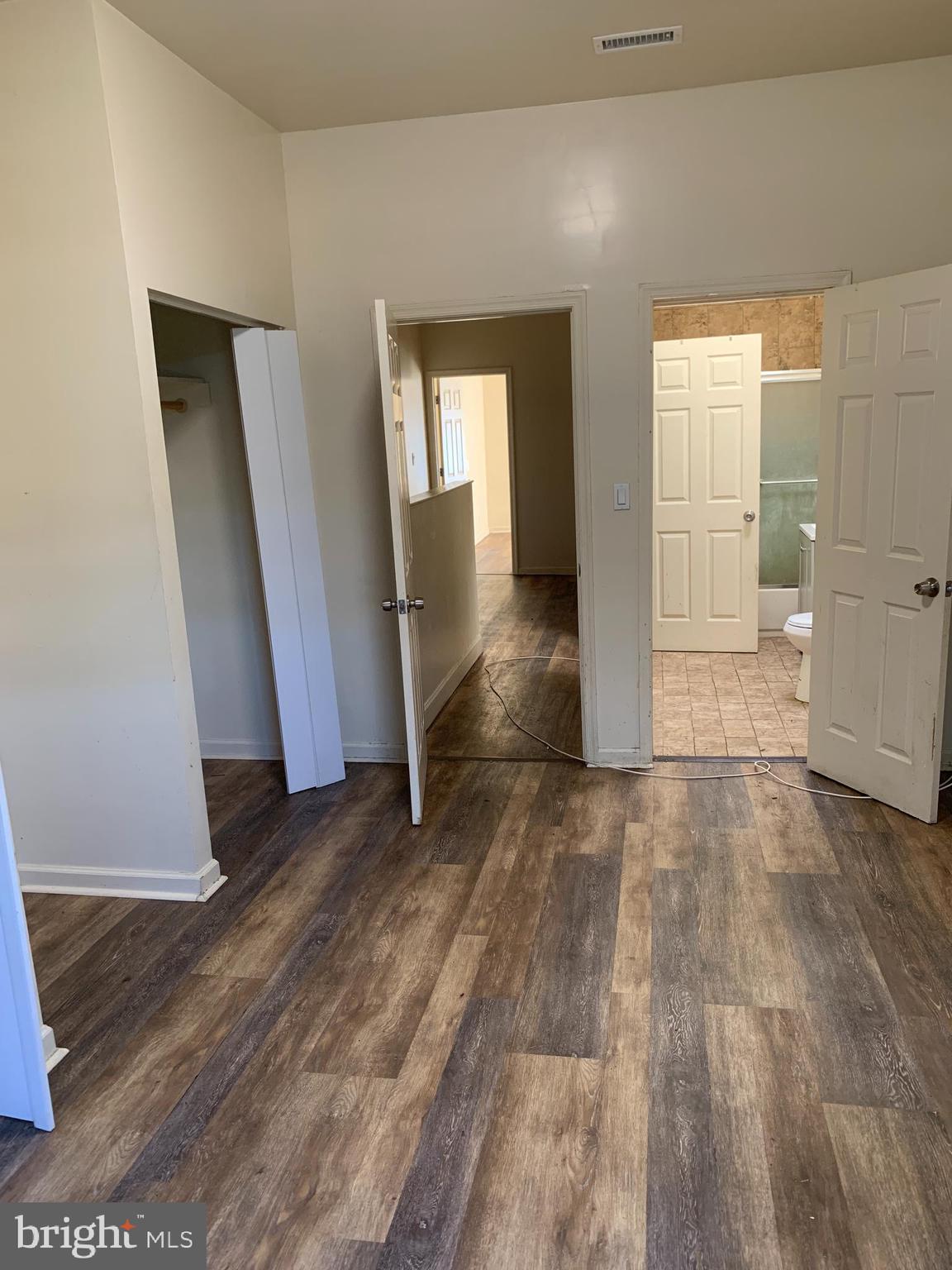 322 North Pulaski Street Baltimore, MD 21223 - Photo 14 of 26 an empty room with wooden floor and windows