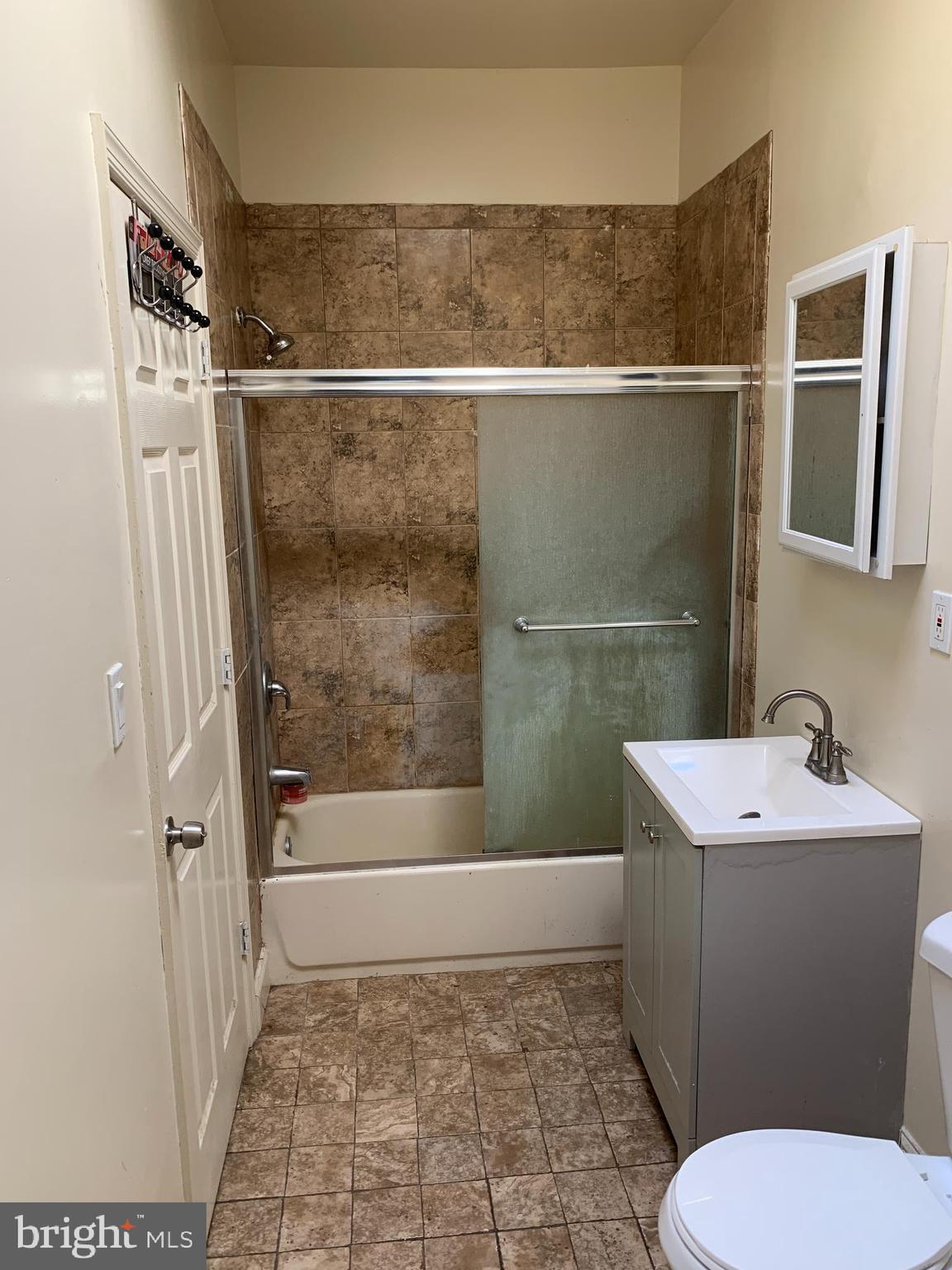 322 North Pulaski Street Baltimore, MD 21223 - Photo 15 of 26 a bathroom with a sink toilet and shower