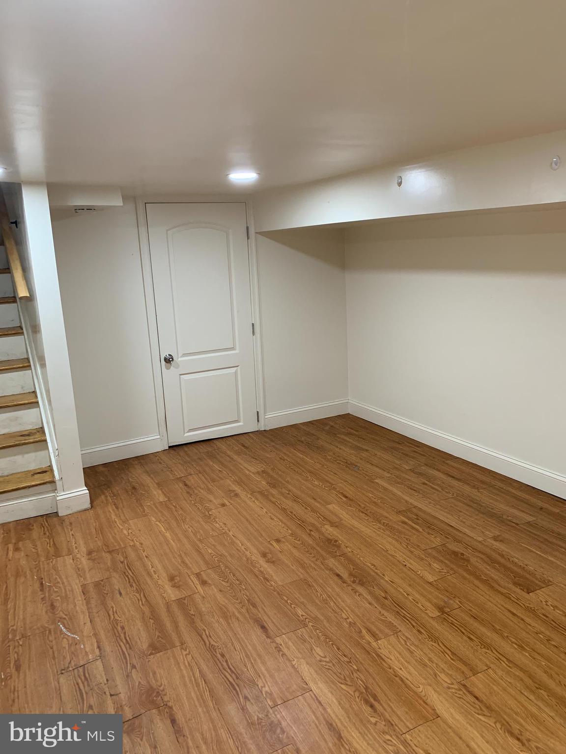 322 North Pulaski Street Baltimore, MD 21223 - Photo 21 of 26 a view of an empty room with wooden floor