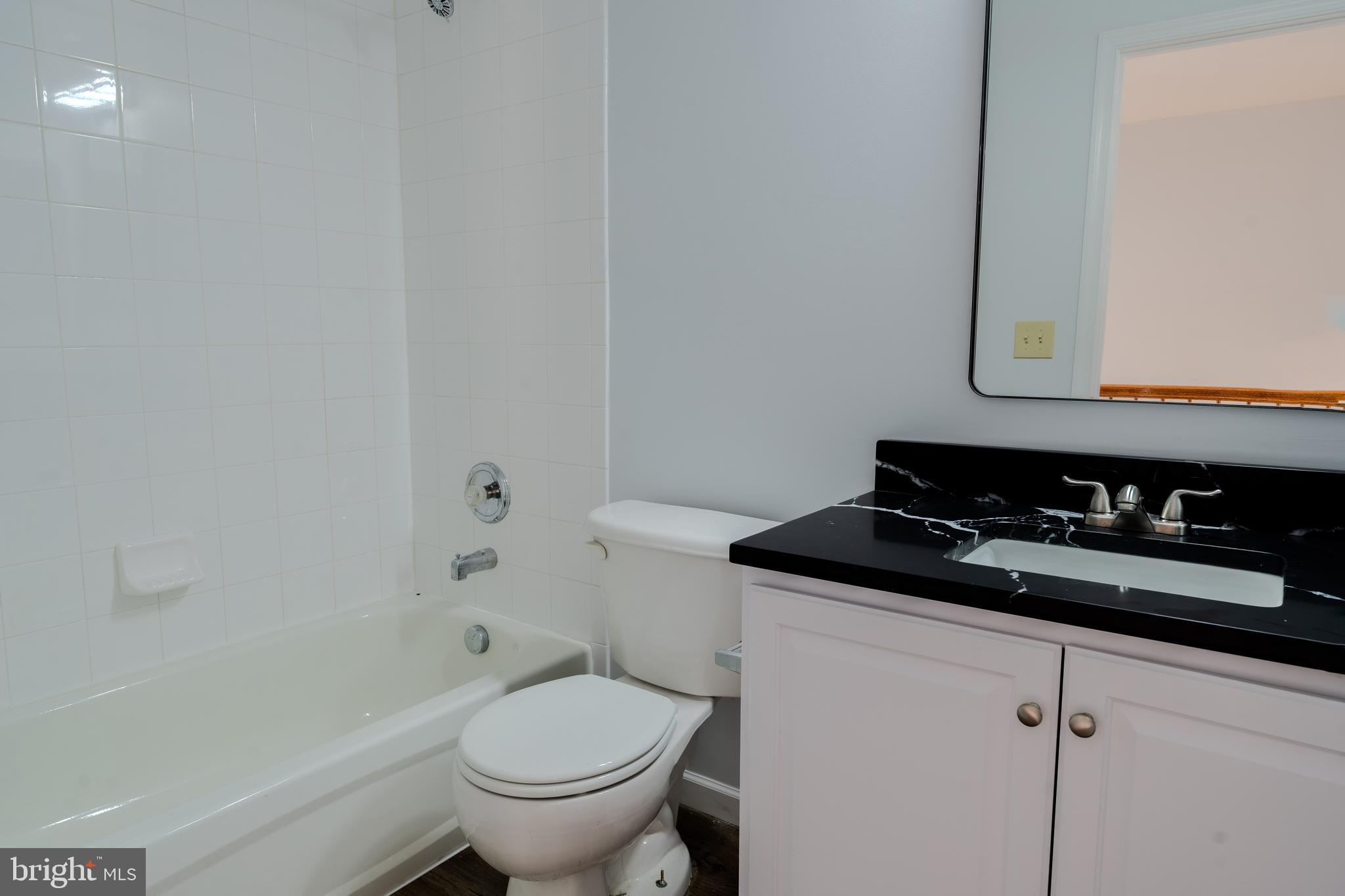 2011 Weitzel Court Frederick, MD 21702 - Photo 20 of 49 a bathroom with a granite countertop toilet a sink and bathtub