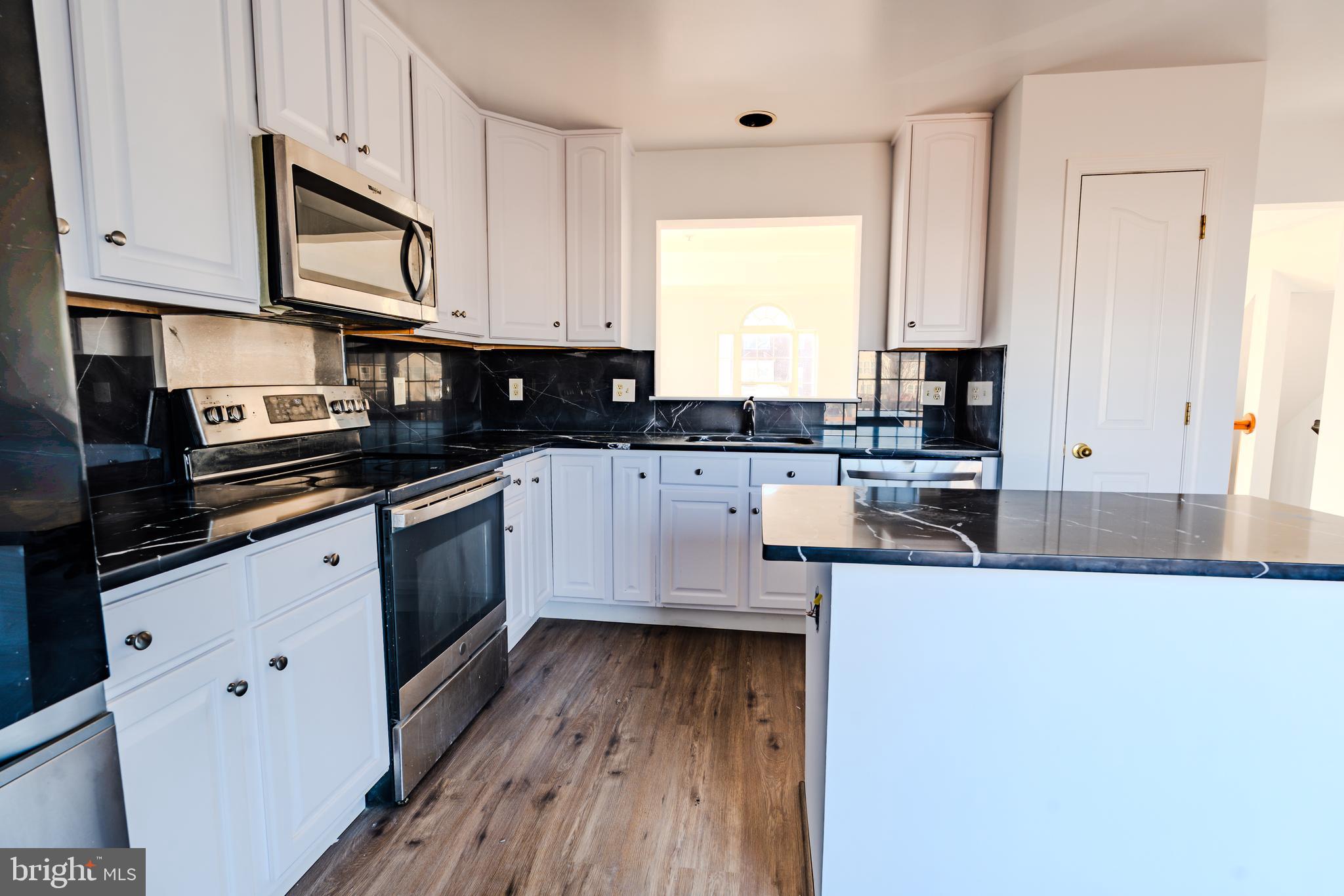 2011 Weitzel Court Frederick, MD 21702 - Photo 21 of 49 a kitchen with stainless steel appliances a sink a stove top oven a counter space and cabinets