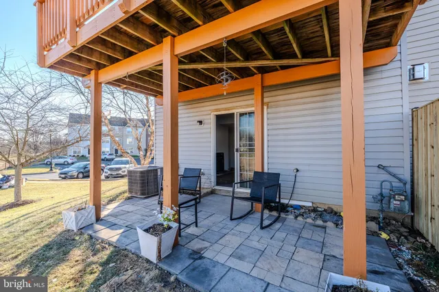 a view of a patio with table and chairs and wooden floor