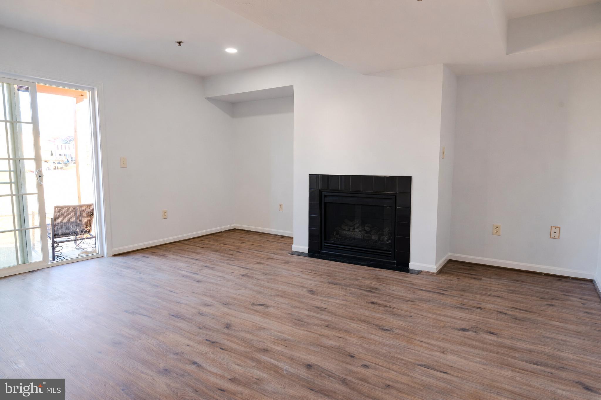 2011 Weitzel Court Frederick, MD 21702 - Photo 33 of 49 a view of an empty room with wooden floor and a window