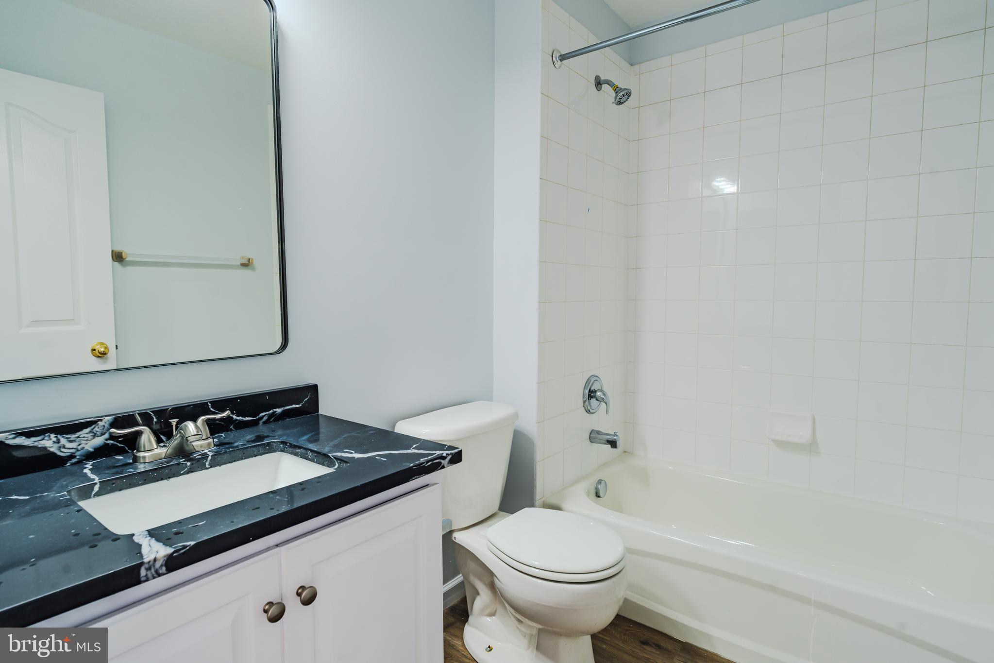 2011 Weitzel Court Frederick, MD 21702 - Photo 42 of 49 a bathroom with a granite countertop sink and a mirror