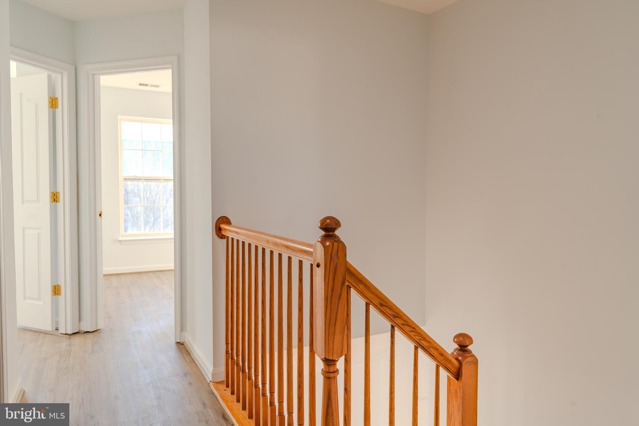 2011 Weitzel Court Frederick, MD 21702 - Photo 45 of 49 a view of a hallway with wooden floor and a window