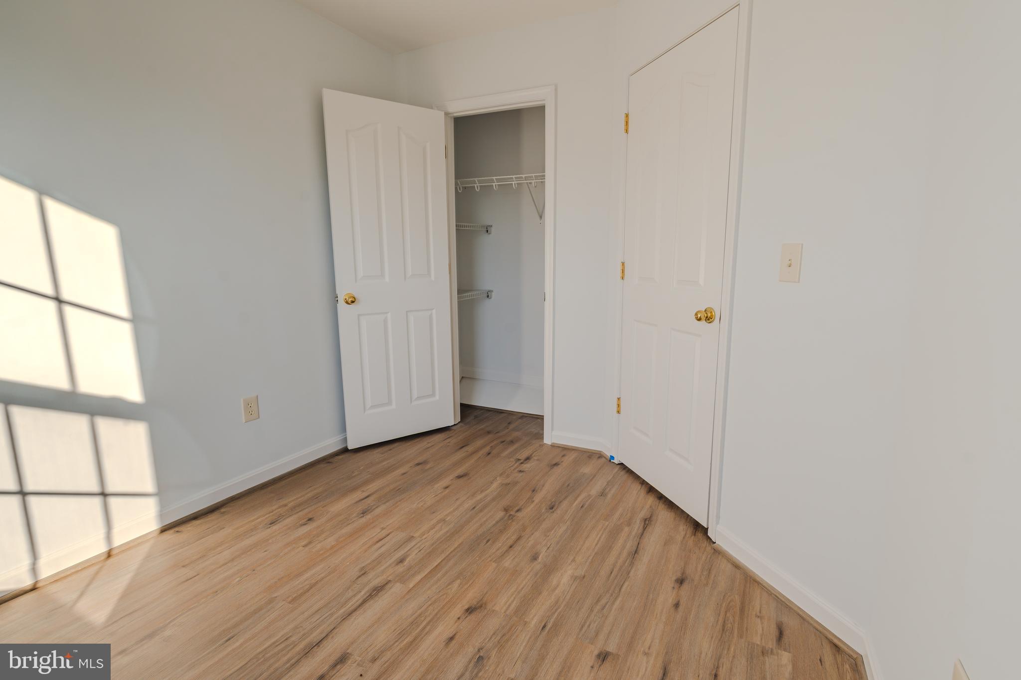 2011 Weitzel Court Frederick, MD 21702 - Photo 46 of 49 a view of an empty room with wooden floor and a window
