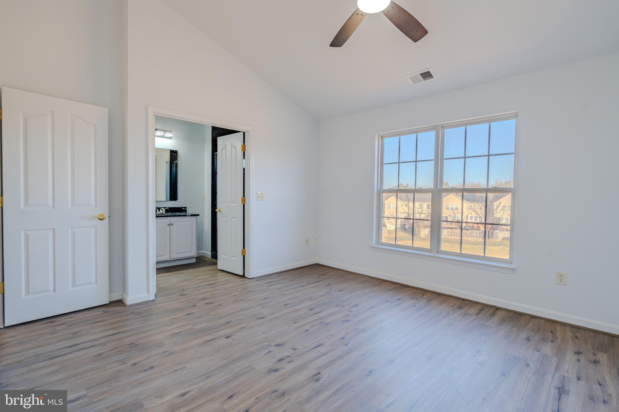 2011 Weitzel Court Frederick, MD 21702 - Photo 6 of 49 an empty room with chandelier fan and windows
