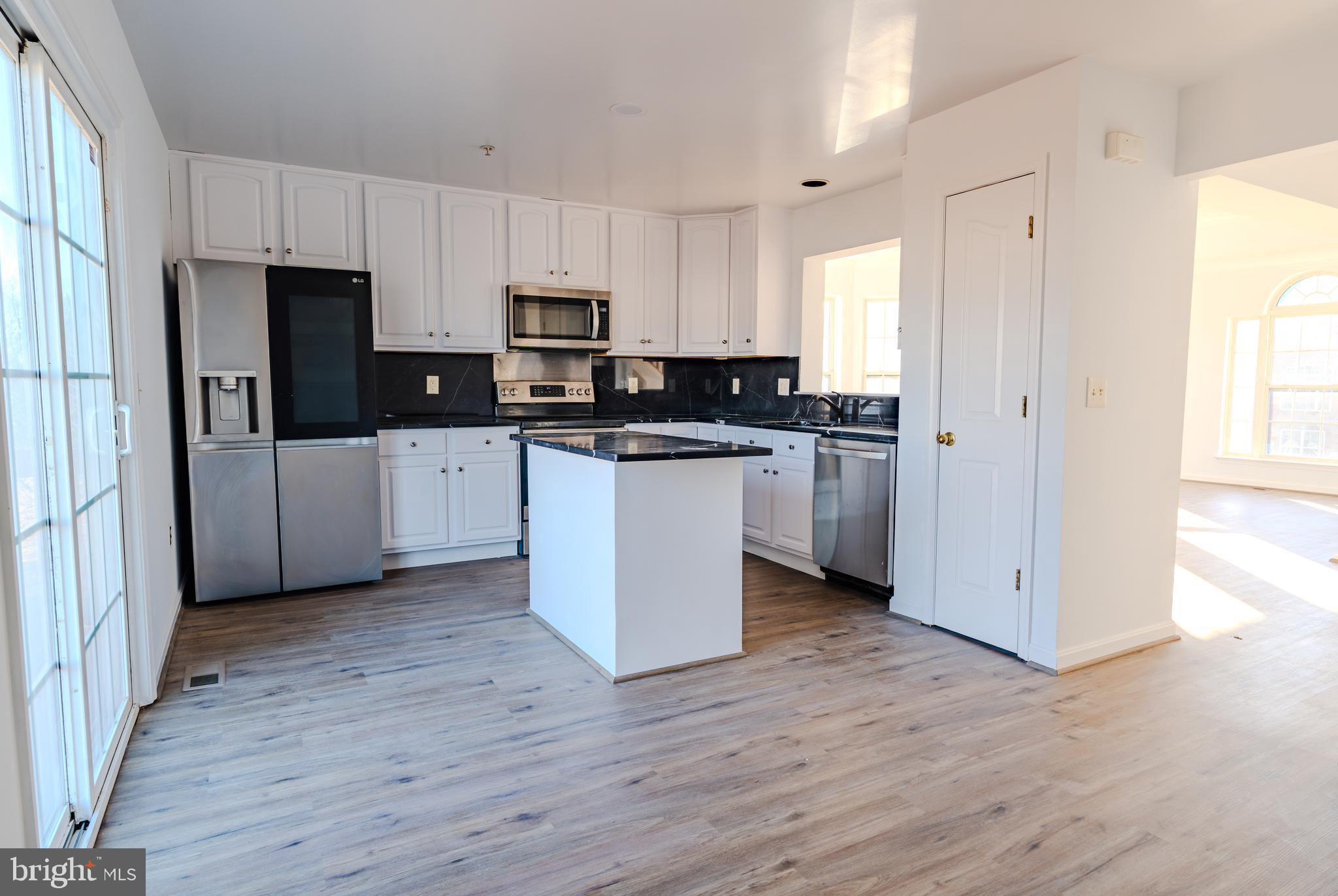 2011 Weitzel Court Frederick, MD 21702 - Photo 9 of 49 a kitchen with stainless steel appliances a refrigerator stove and sink