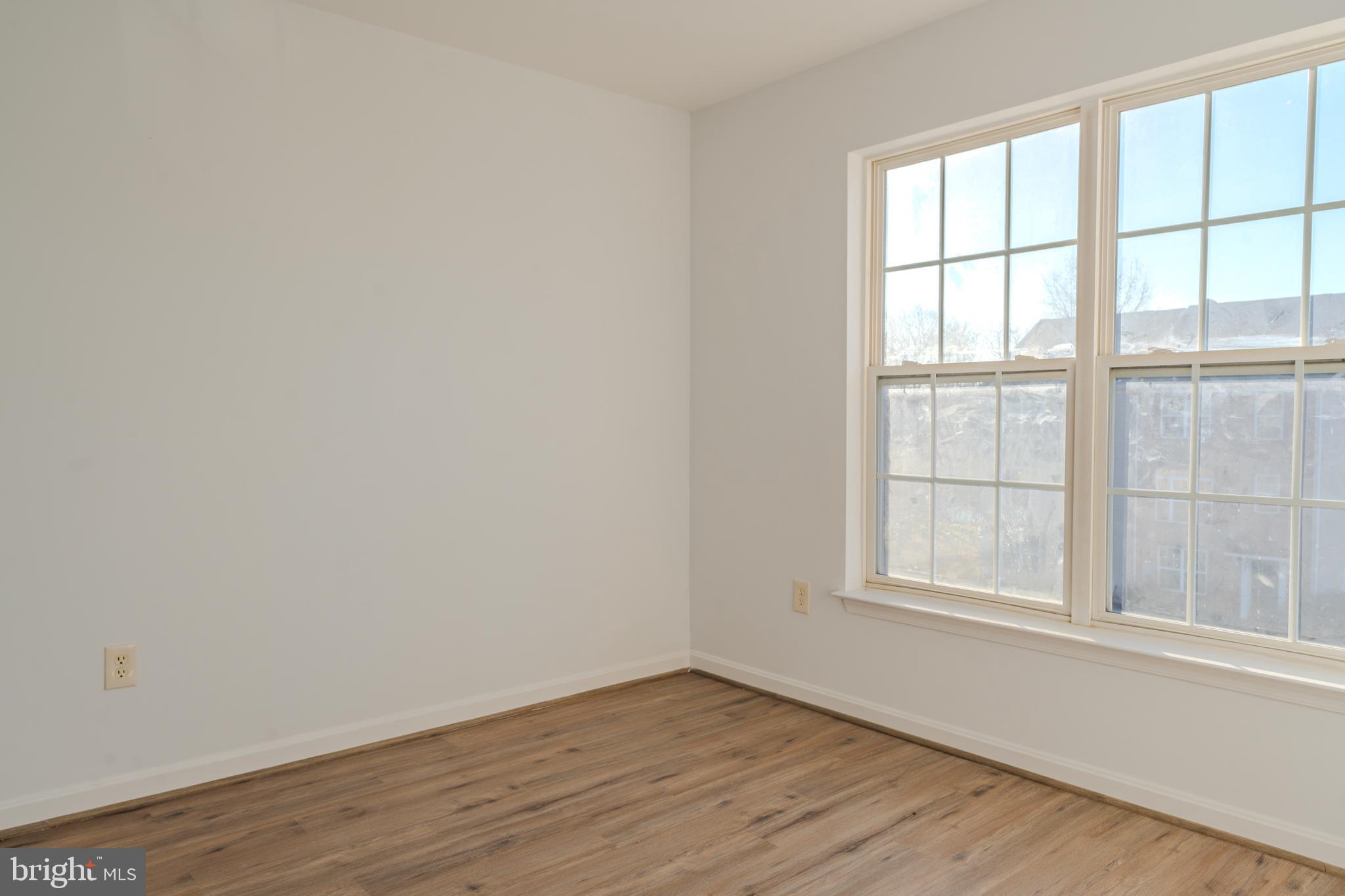 2011 Weitzel Court Frederick, MD 21702 - Photo 10 of 49 an empty room with wooden floor and windows