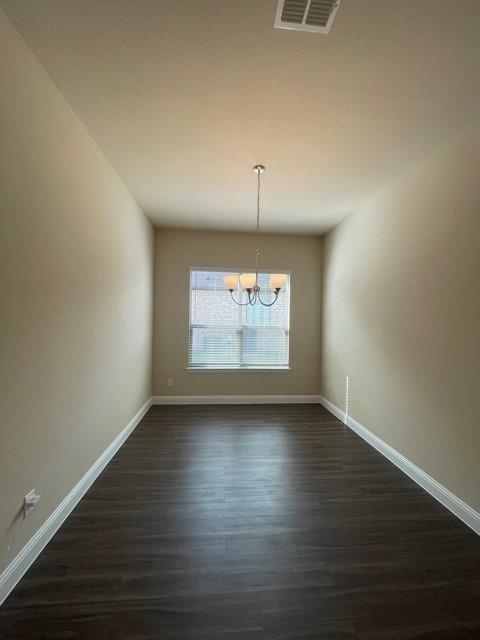 569 Spruce Trail Forney, TX 75126 - Photo 15 of 22 Unfurnished dining area with suspended lighting and dark wood-type flooring