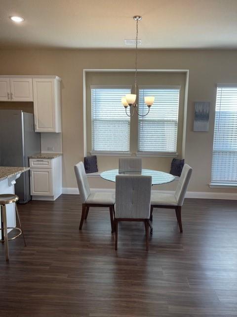 569 Spruce Trail Forney, TX 75126 - Photo 17 of 22 Dining room featuring dark wood-style floors and hanging lights