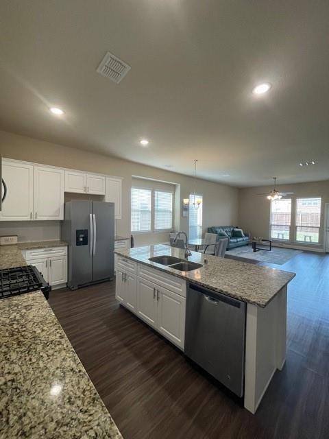 569 Spruce Trail Forney, TX 75126 - Photo 22 of 22 Kitchen with white cabinetry, light stone countertops, open floor plan, dark wood-style floors, and stainless steel appliances