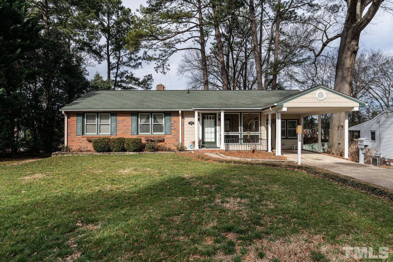 211 Quail Drive Raleigh, NC 27604 - Photo 1 of 28 a front view of a house with a garden