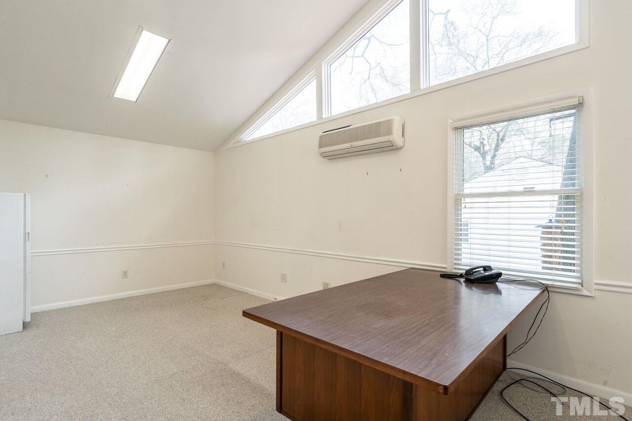211 Quail Drive Raleigh, NC 27604 - Photo 14 of 28 a room with a window a ceiling fan and wooden floor