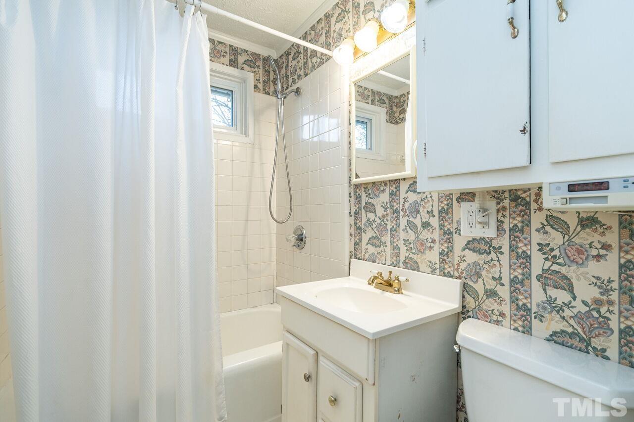 211 Quail Drive Raleigh, NC 27604 - Photo 19 of 28 a bathroom with a sink a toilet and shower