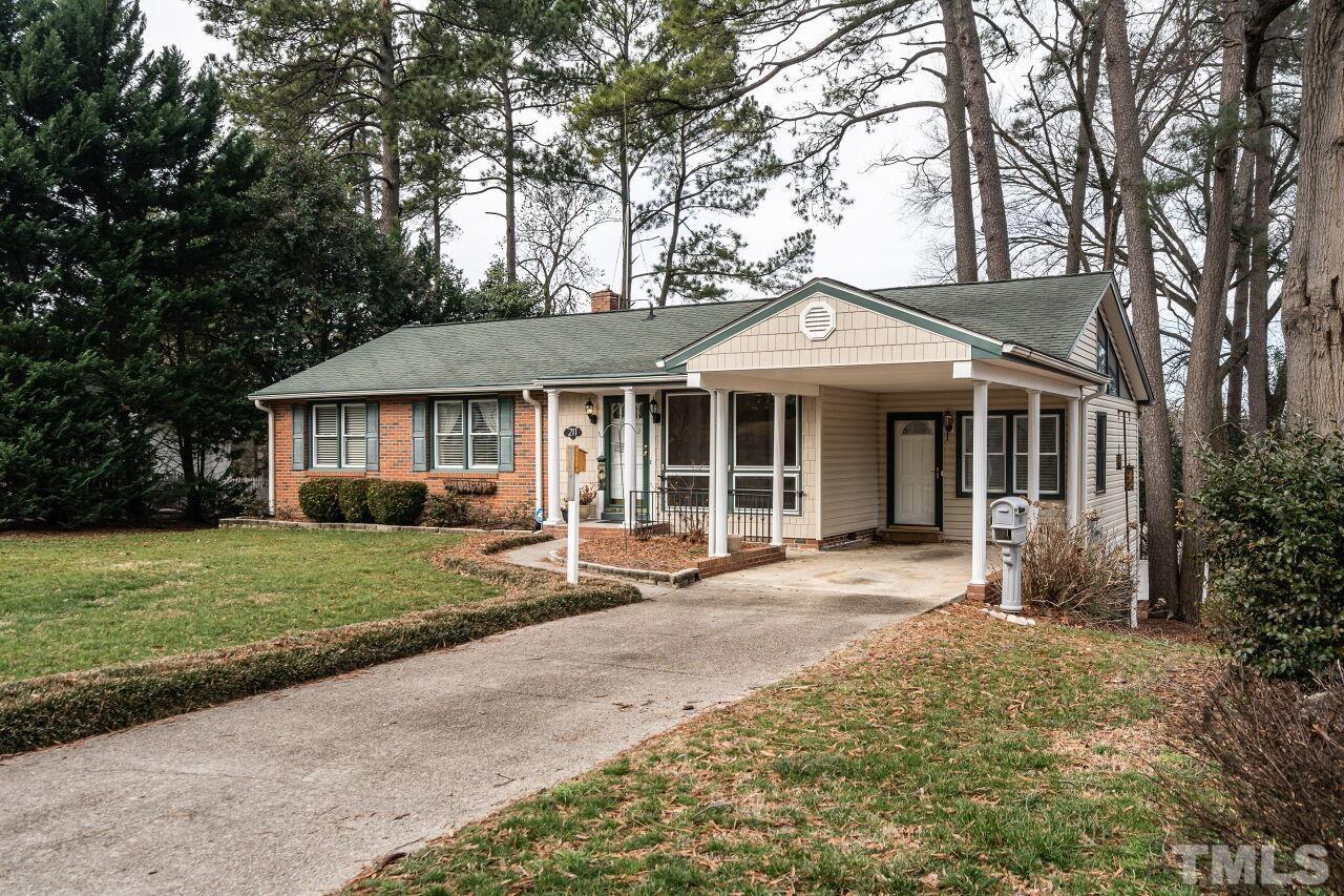 211 Quail Drive Raleigh, NC 27604 - Photo 2 of 28 a front view of a house with a garden and porch