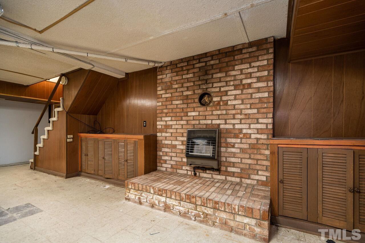 211 Quail Drive Raleigh, NC 27604 - Photo 23 of 28 a view of a door with a fireplace
