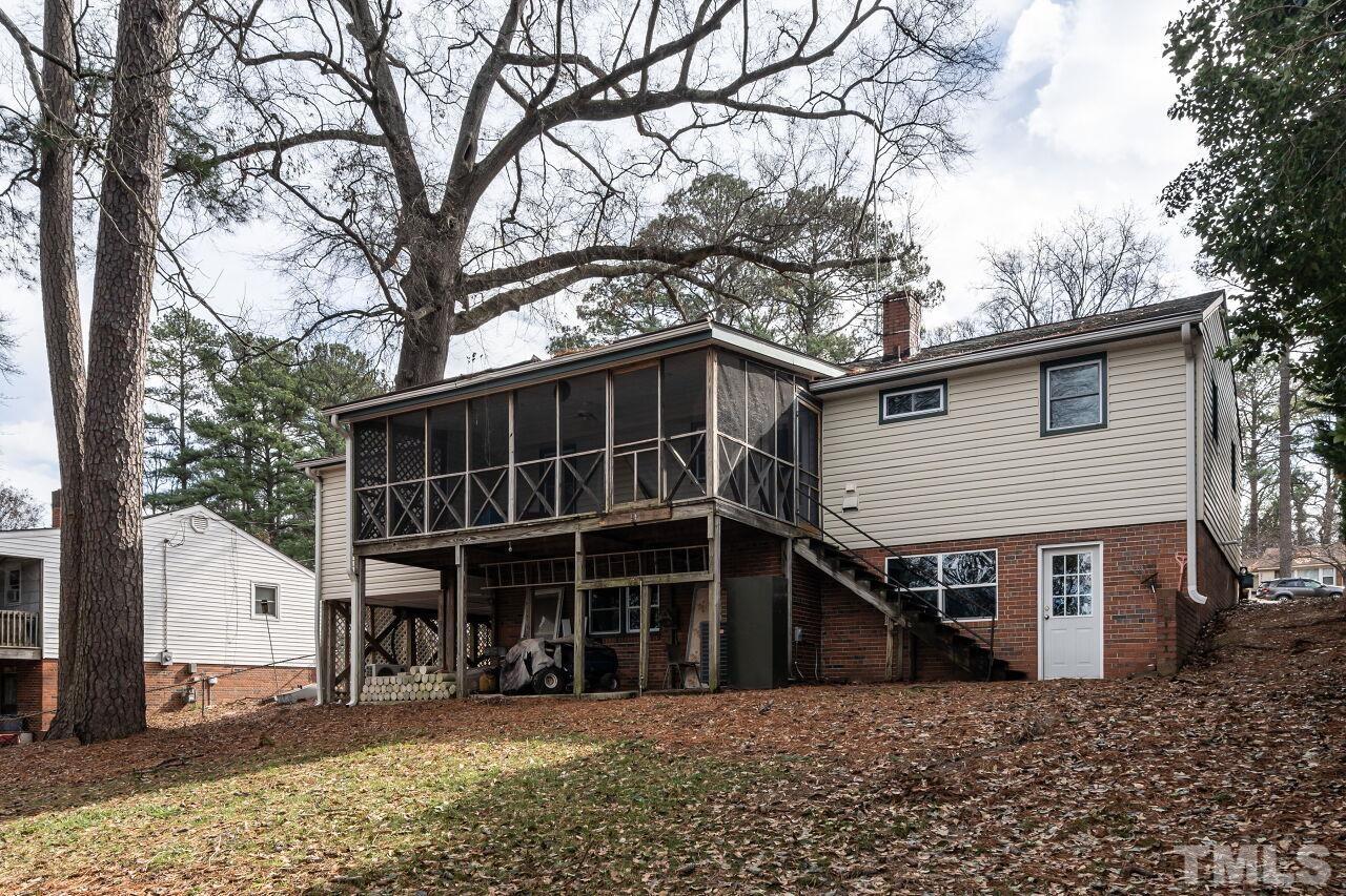 211 Quail Drive Raleigh, NC 27604 - Photo 28 of 28 a view of a house with a large window and a yard